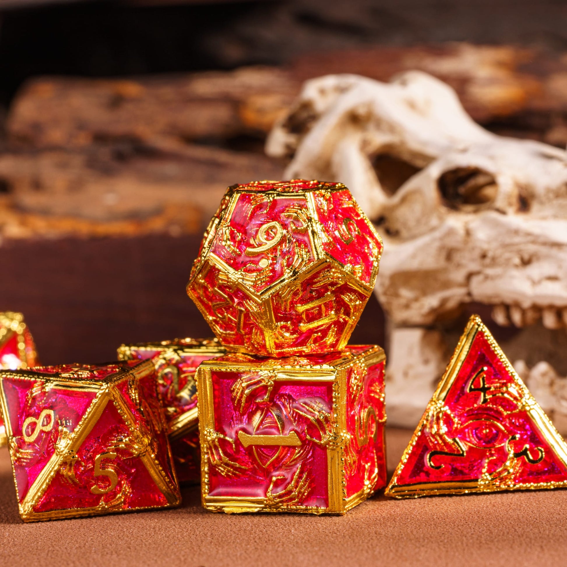 Royal Crypt Metal Dice Set red & gold dice closeup with skull background