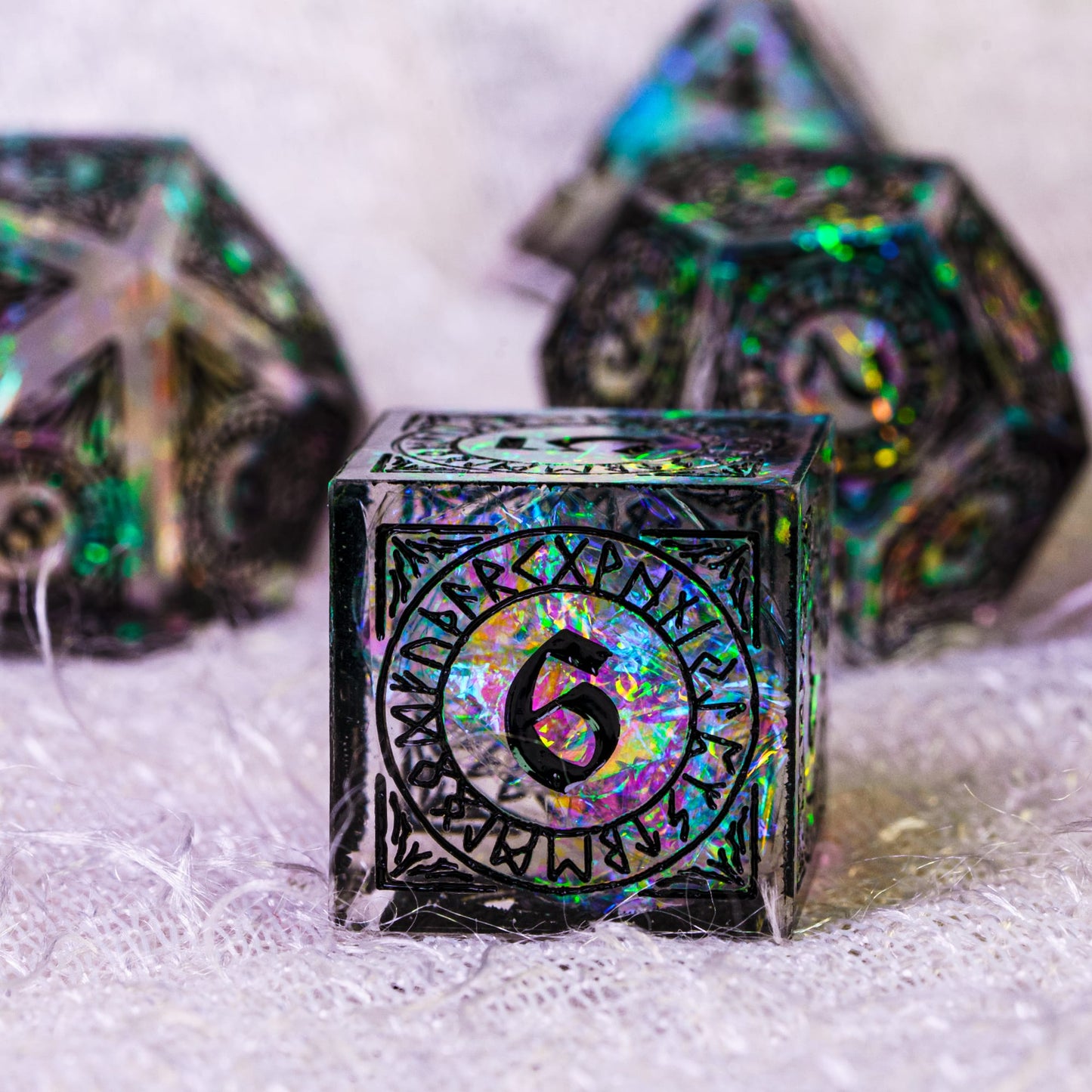 Close-up of Runic Illusion sharp edge D6 showing holographic foil interior and engraved runic symbols