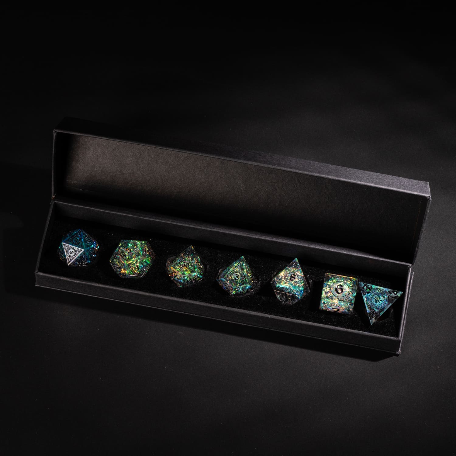 Runic Illusion sharp edge dice set displayed in a black presentation box with holographic runic engravings