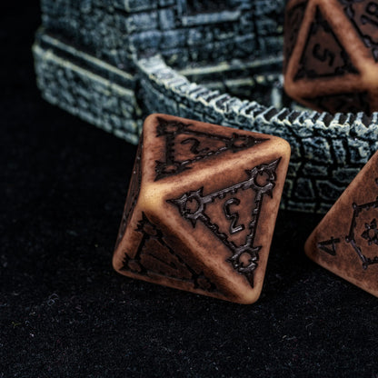 Close up of Sandy Elixir Chonk D4 resin dice for DnD and tabletop RPGs