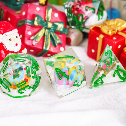 Santa’s Workshop RPG dice with clear resin and green numbers featuring snowman miniatures inside