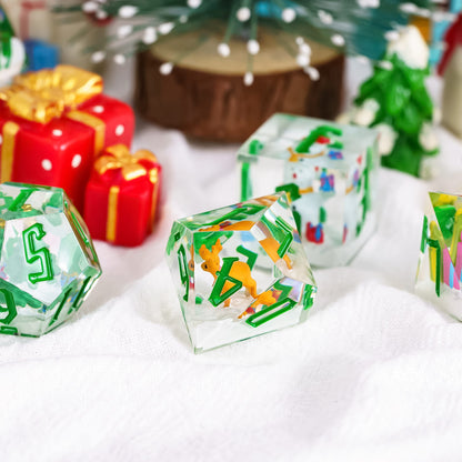 Santa's Workshop sharp edge resin dice set showing D20, D10, and D8 with Christmas minis in clear resin