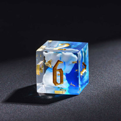 Shimmering Shoals D6 sharp edge die with blue and white resin waves and gold numbering