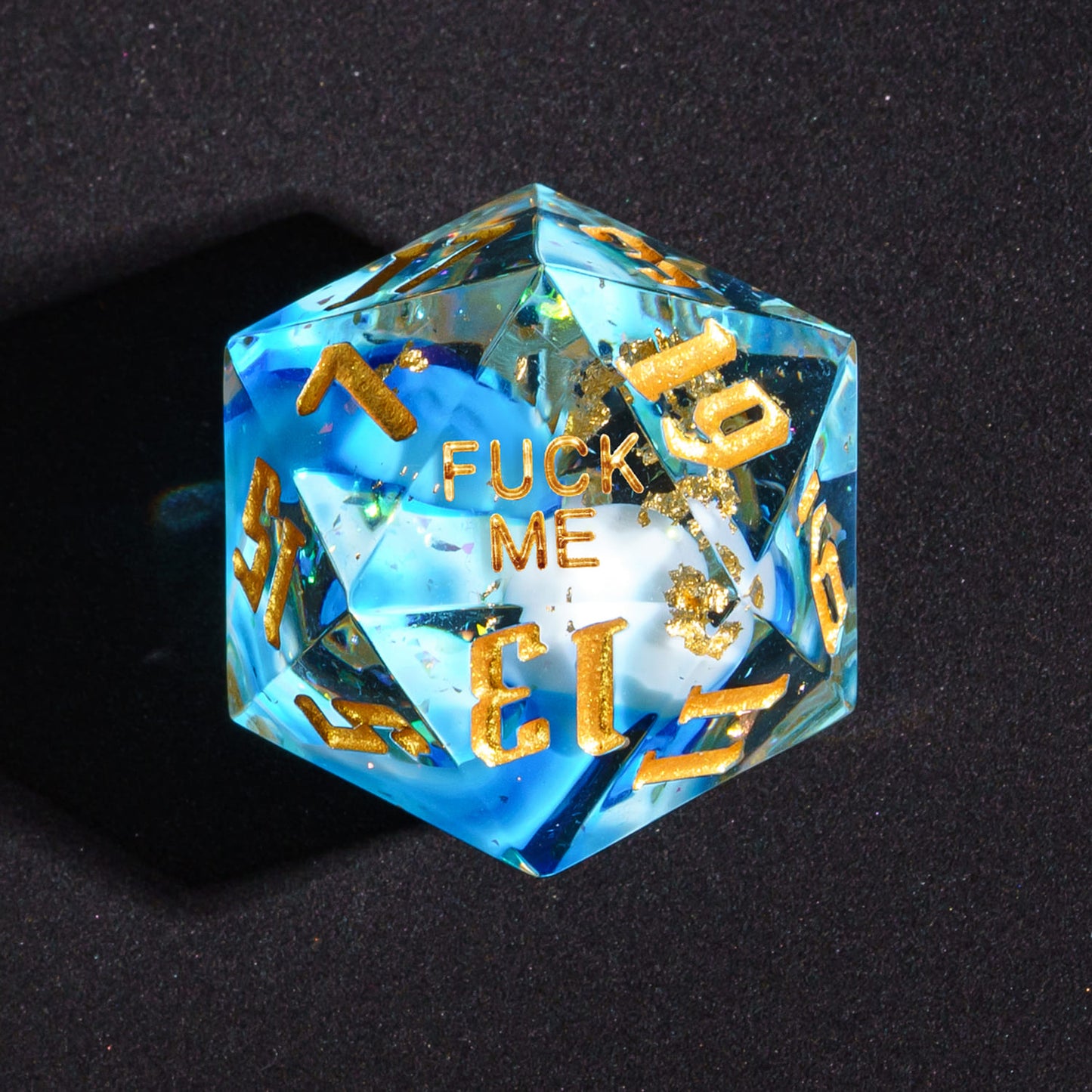 Close up of Shimmering Shoals Sharp Edge D20 with Fuck Me face for DnD dice