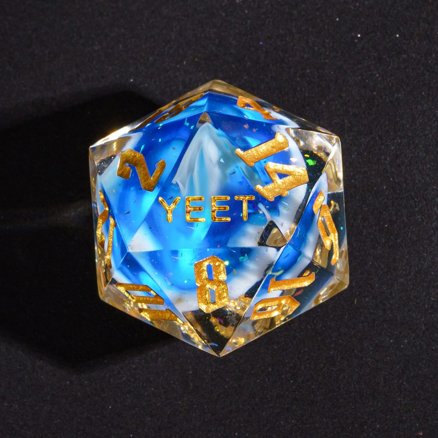 Close up of Shimmering Shoals Sharp Edge D20 with YEET face for DnD dice