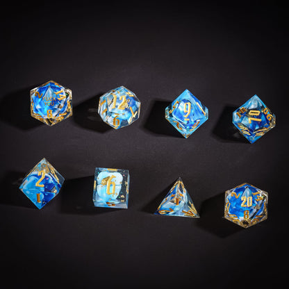 Flat lay of Shimmering Shoals Sharp Edge Dice Set 8 piece resin dice for DnD