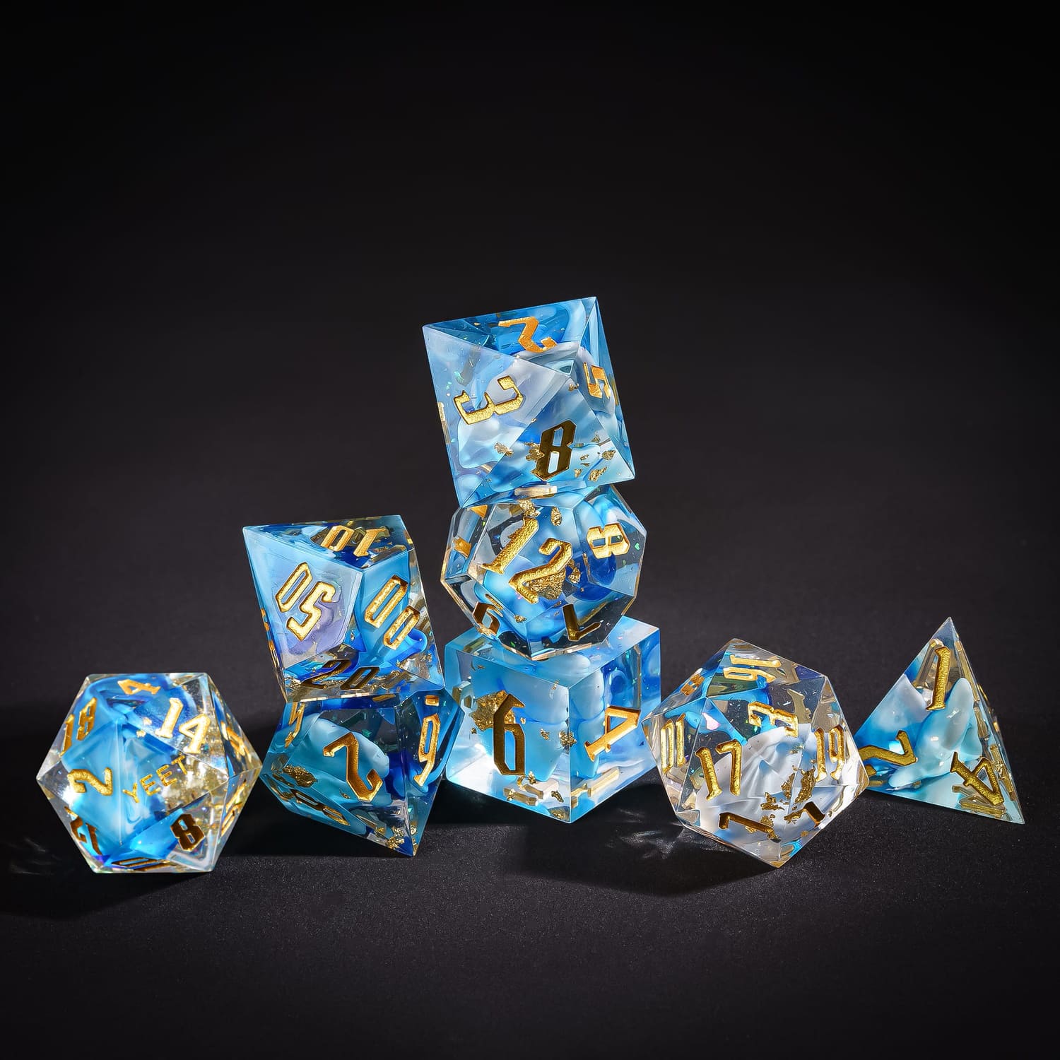 Stacked display of Shimmering Shoals Yeet Sharp Edge Dice Set for DnD collectors