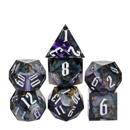 Siren’s Cache sharp edge DnD dice set with dark resin, purple swirls, gold foil, and silver numbering on white background