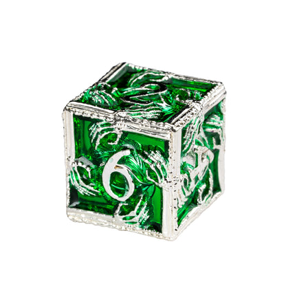 Close up of Siren's Crypt metal D6 with emerald green inlay and engraved silver dragon design