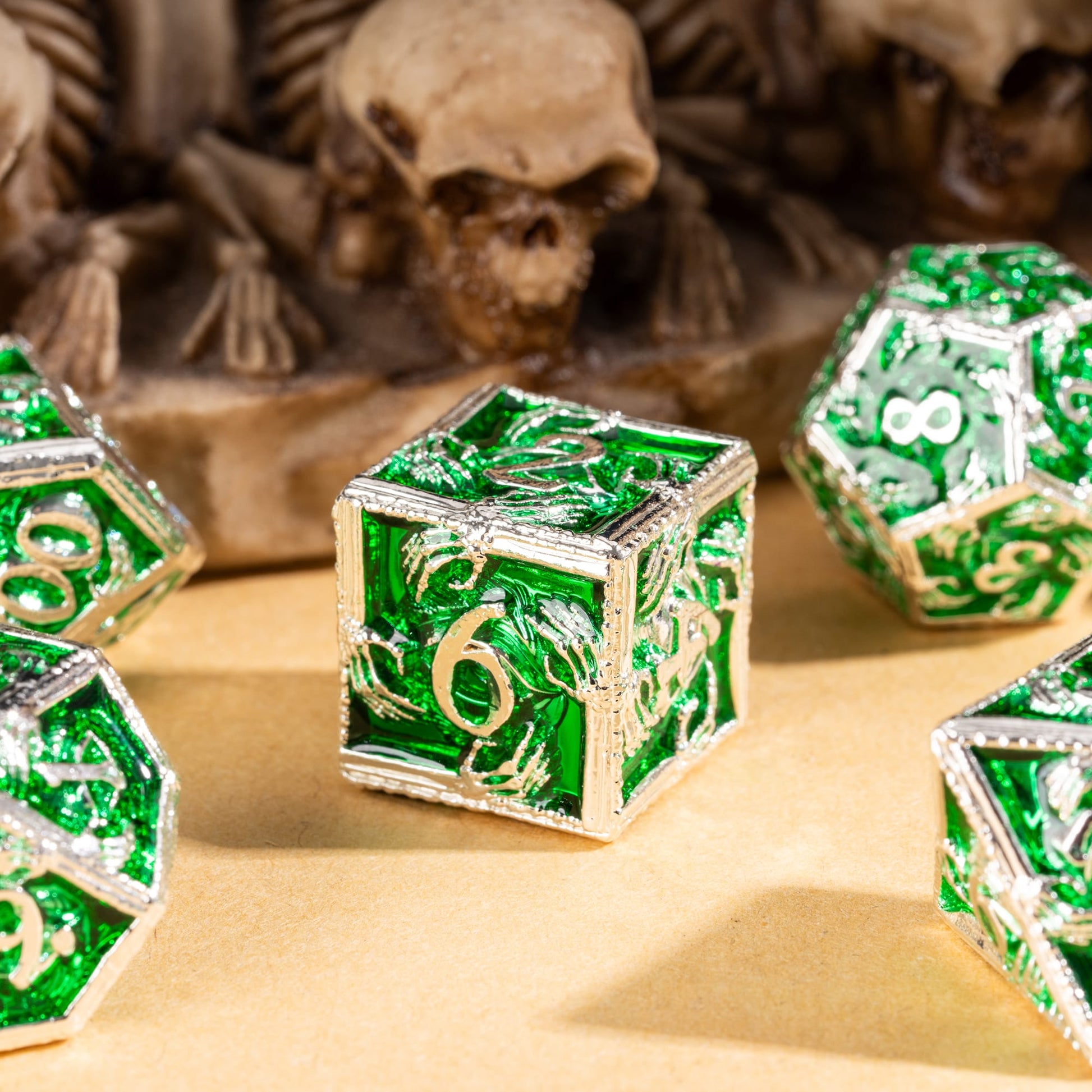 Hero shot of Siren's Crypt metal D6 with emerald inlay and silver skeleton detailing