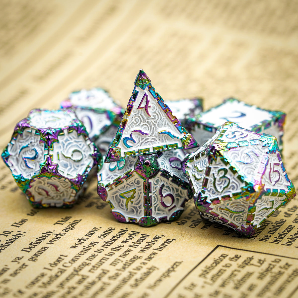 Snow Blade metal dagger dice set for DnD & TTRPG, angled view on book