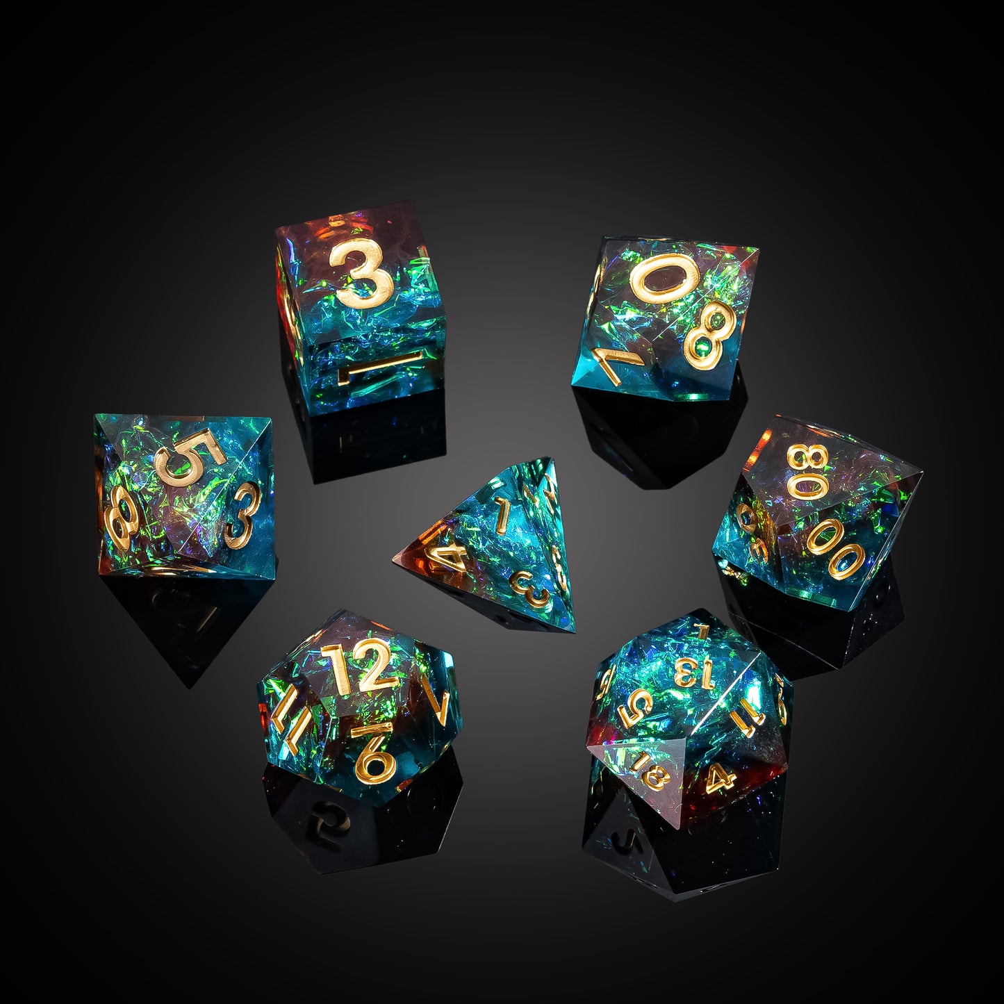 Flat lay of Starlight Nebula sharp edge dice set with blue green iridescent resin and gold numbering