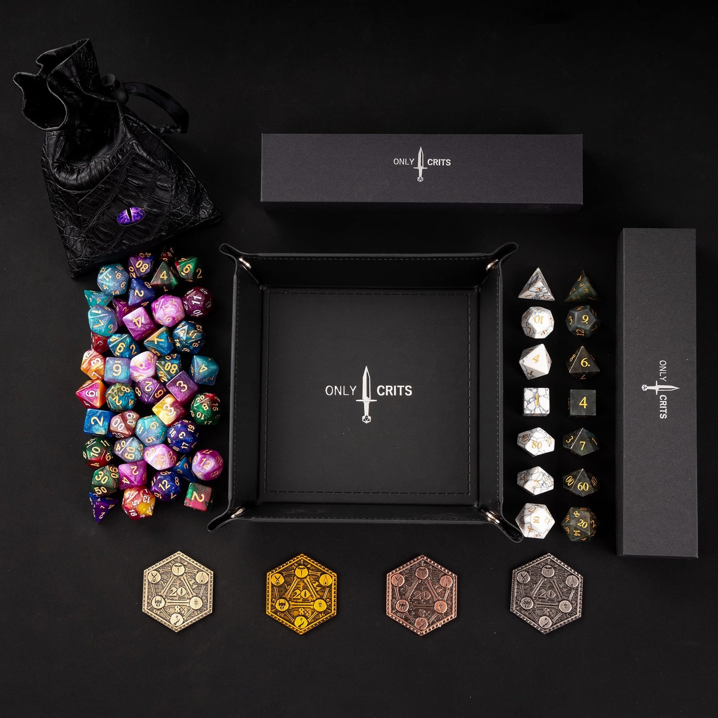 Colorful tabletop dice collection displayed with premium stone dice sets and Only Crits rolling tray