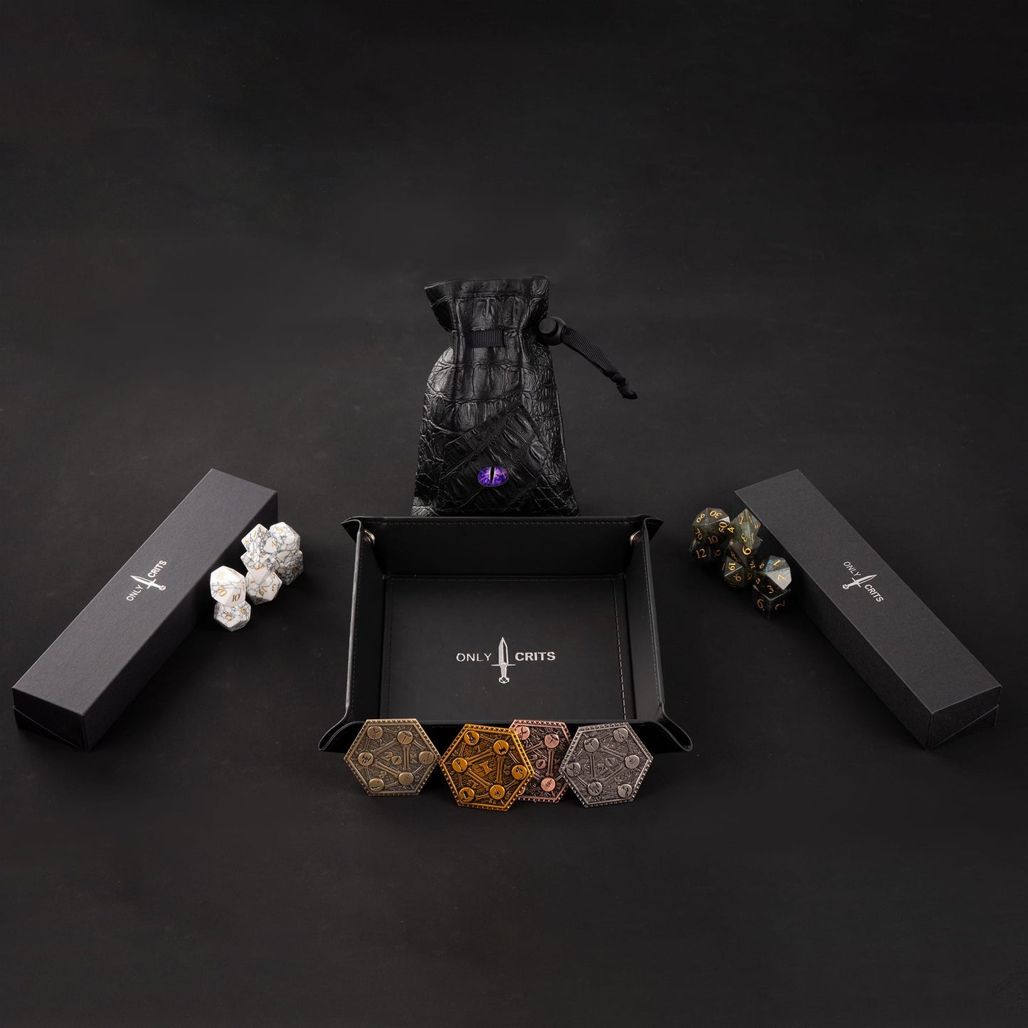 Minimal flat lay of the Only Crits Stone Dice Bundle with stone dice sets and tabletop accessories