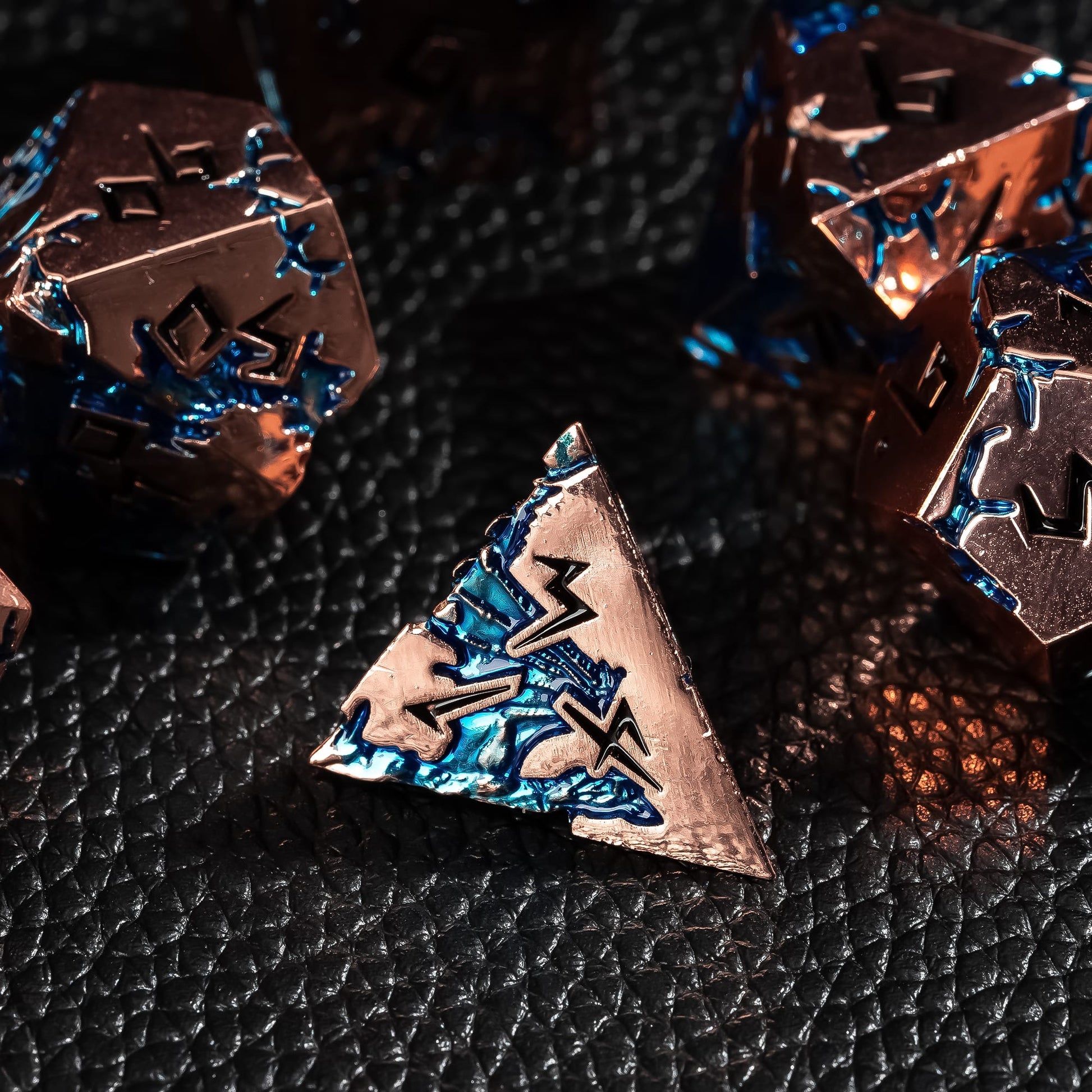 Stormwake Dragon metal D4 close up with blue inlay on dark fantasy background