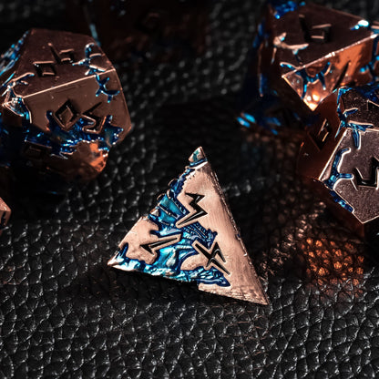 Stormwake Dragon metal D4 close up with blue inlay on dark fantasy background