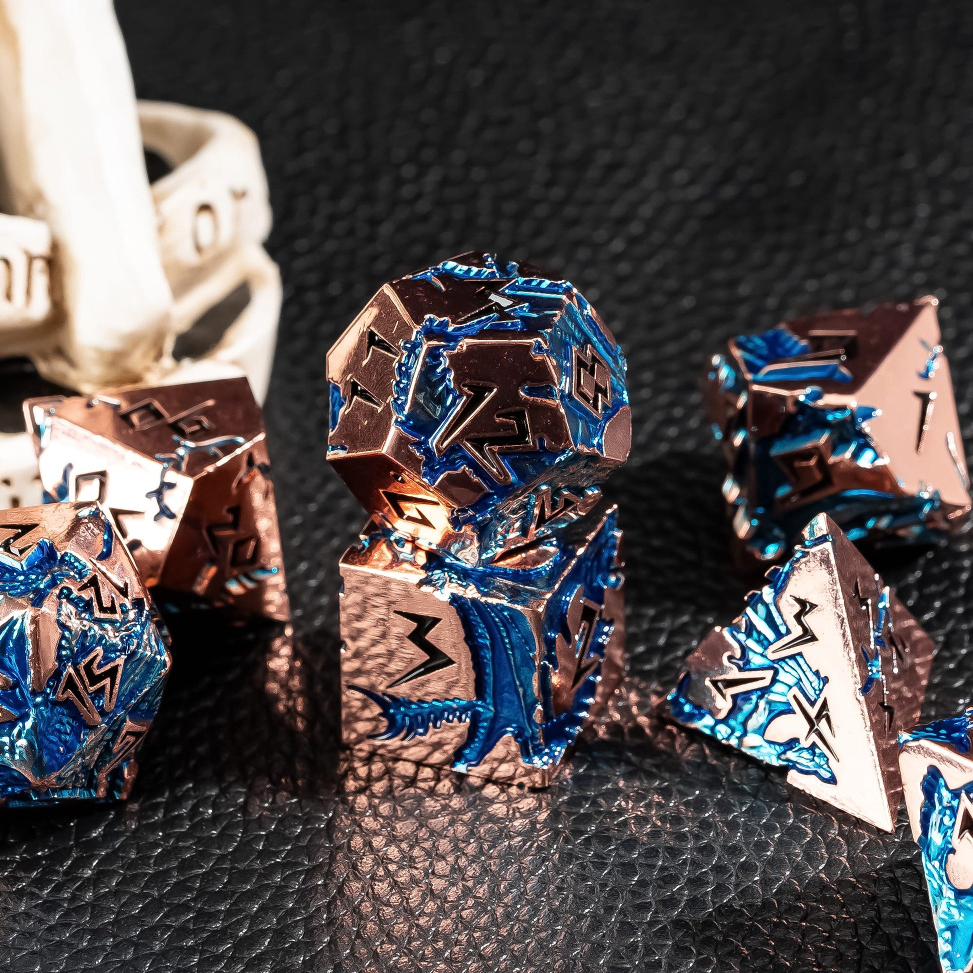 Stormwake Dragon metal dice set styled in dark fantasy tabletop RPG scene