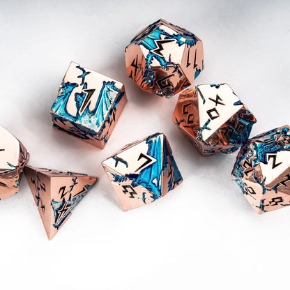 Stormwake Dragon 7 piece metal dice set flat lay with rose gold and blue detailing