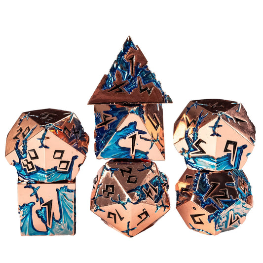Stacked Stormwake Dragon metal dice set with rose gold finish and blue inlay for DnD