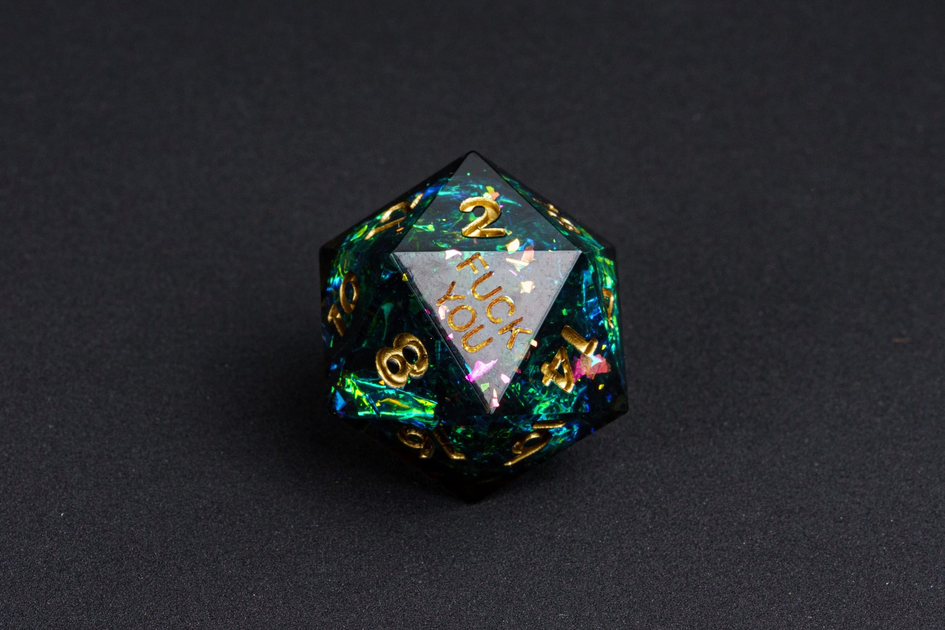 Close up of Supernova Remnant F*ck Me Sharp Edge D20 dice with galaxy-like shimmer for DnD & TTRPGs