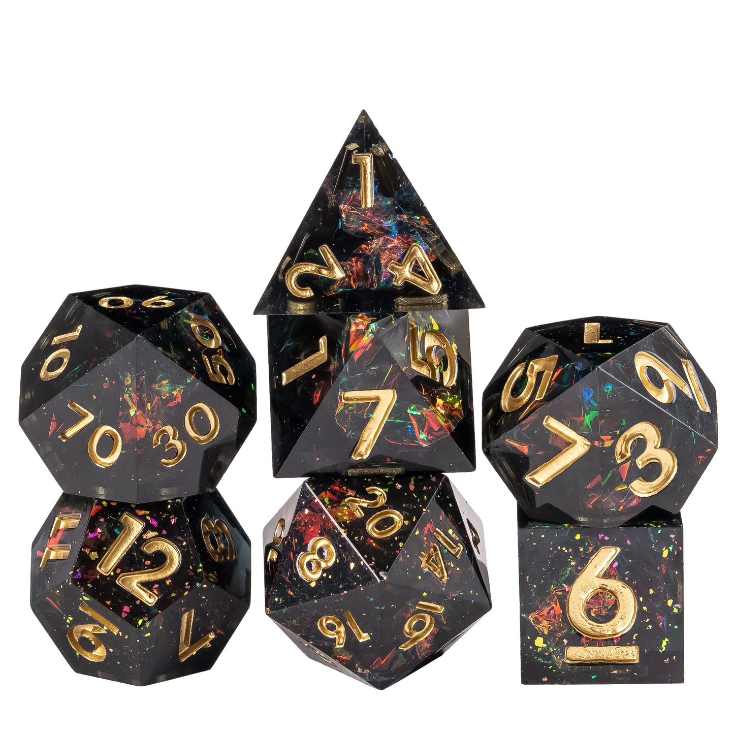Stacked display of Supernova Remnant Sharp Edge 7 piece dice set with black resin, iridescent foil flakes, and gold numbering for DnD
