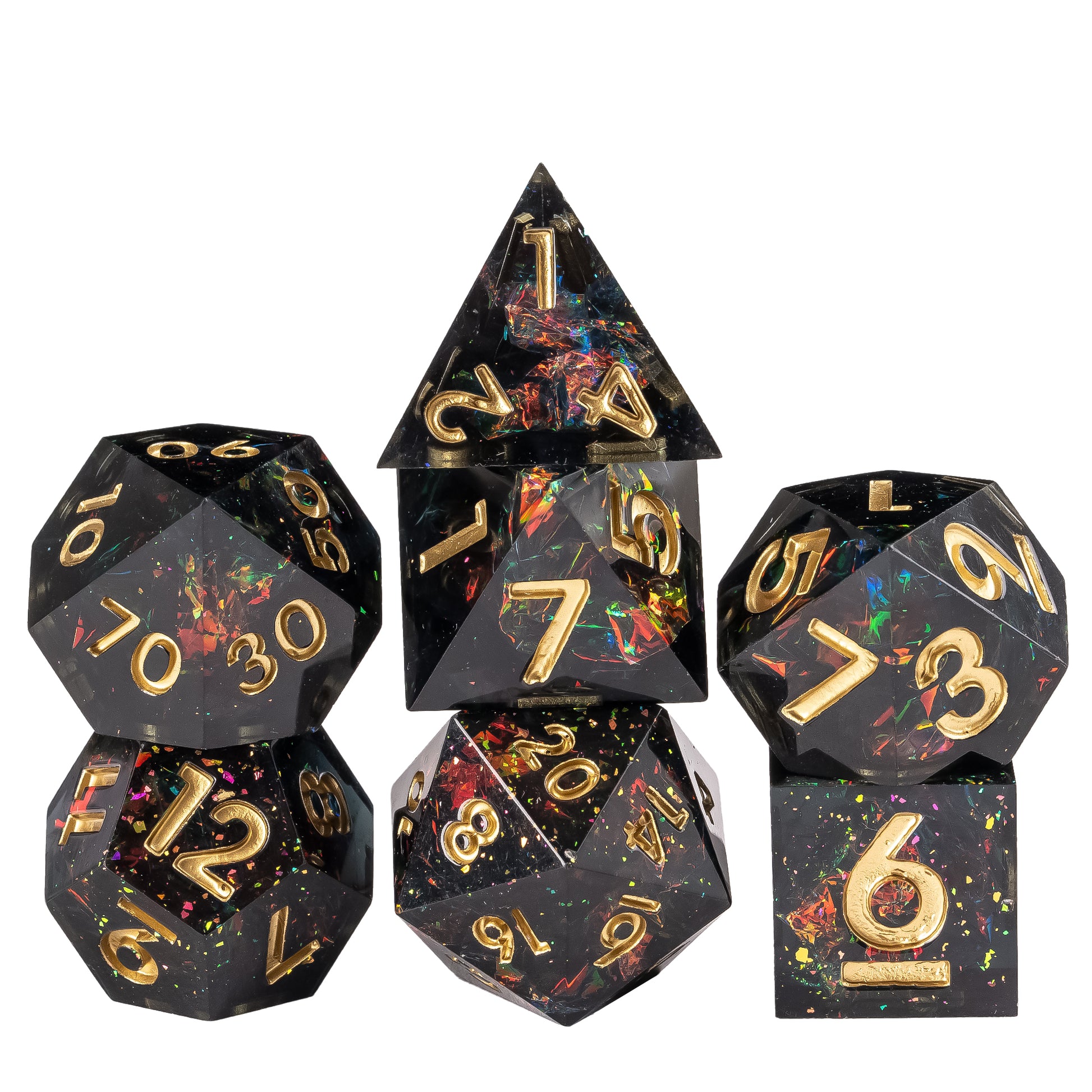 Stacked display of Supernova Remnant Sharp Edge 7 piece dice set with black resin, iridescent foil flakes, and gold numbering for DnD