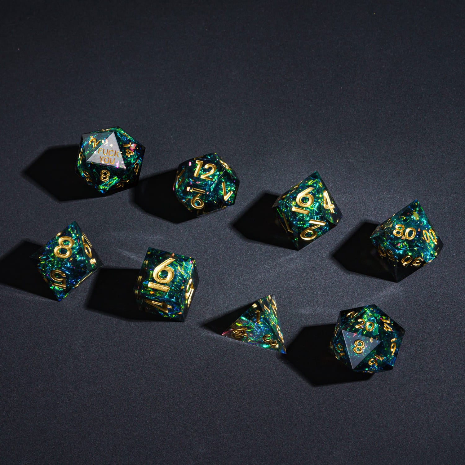 Flat lay of Supernova Remnant F*ck Me Sharp Edge Dice Set 7 piece collection for DnD & DnD 5e