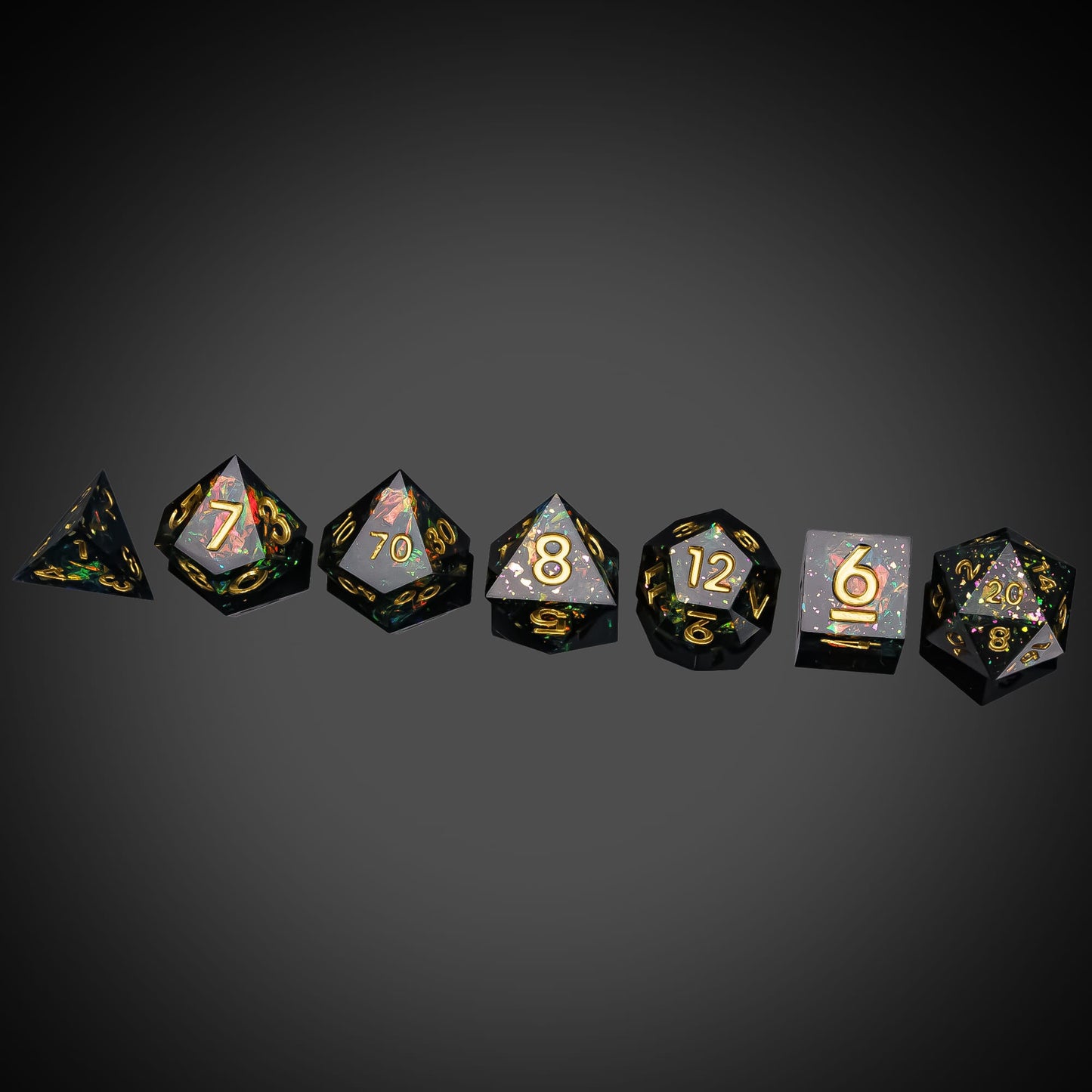 Supernova Remnant sharp edge dice set with black resin and gold numbers on dark background