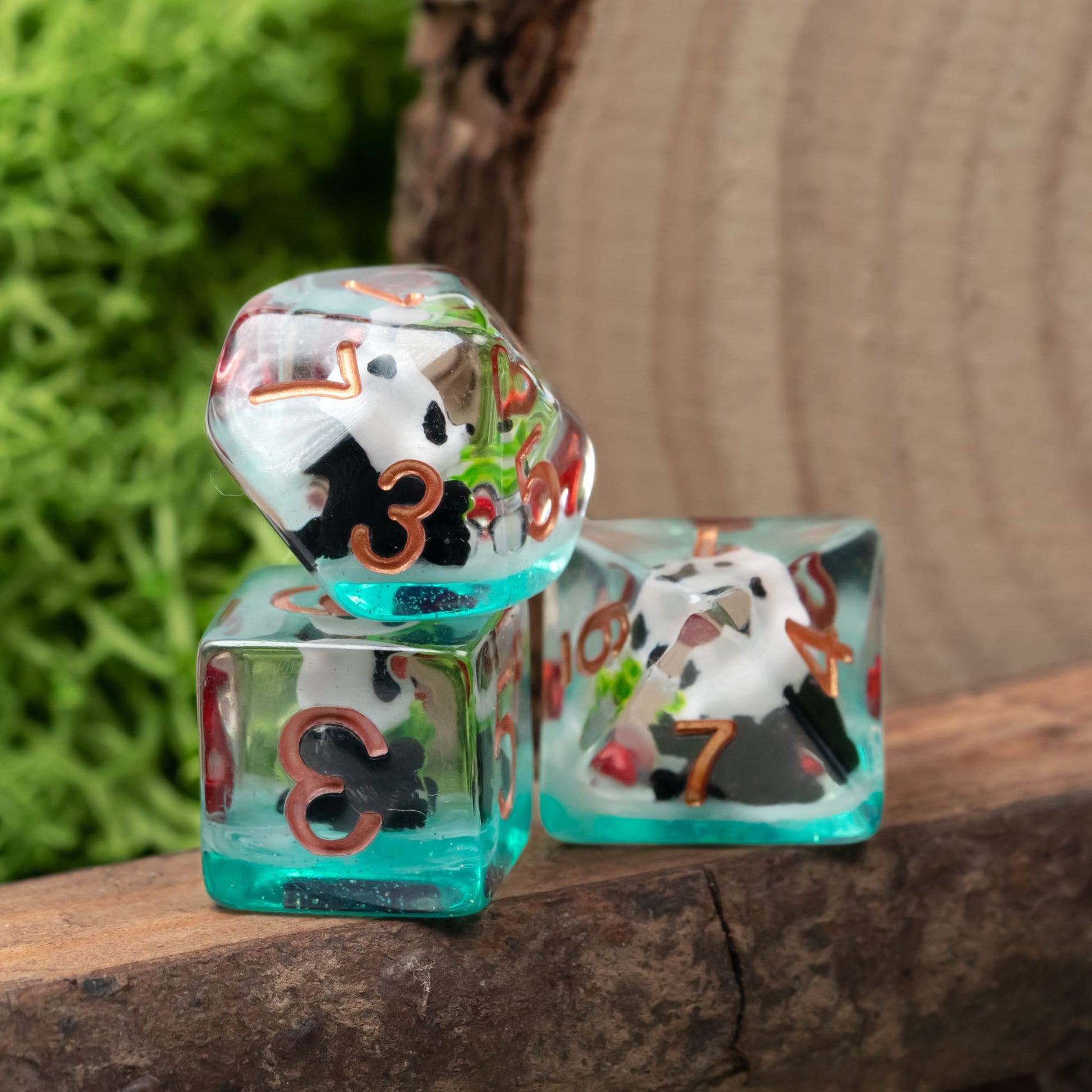 Transparent Bamboo Panda Dice Set displayed on wooden surface with green moss background