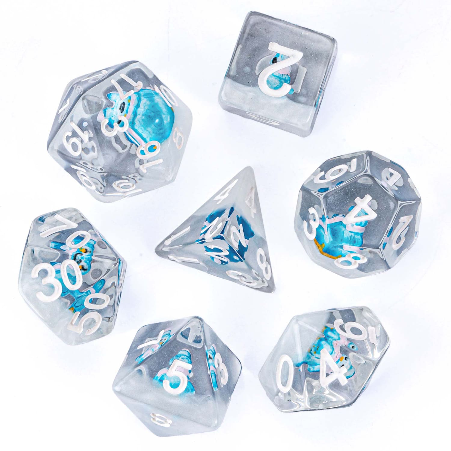 Full 7-piece Transparent Blue Penguin dice set on white background