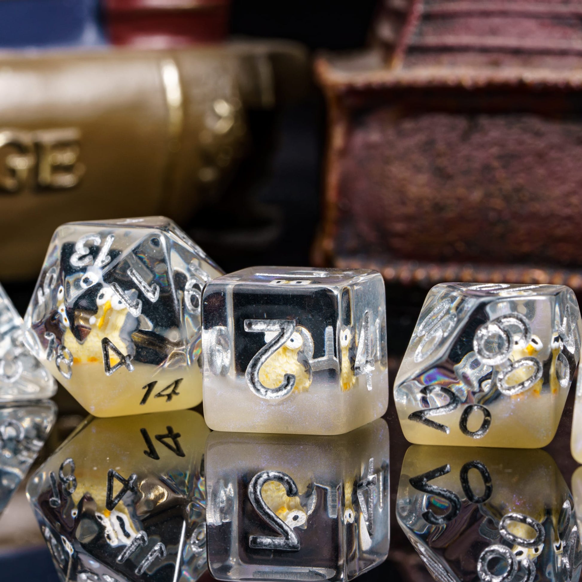 Transparent Brown Owl Dice Set displayed on reflective surface showing owl inside resin dice.