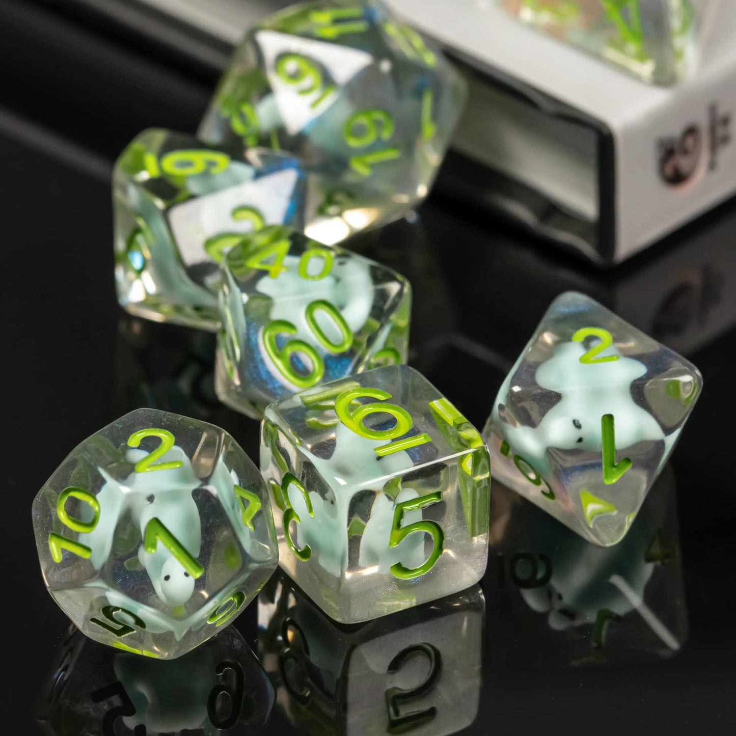 Group of Transparent Dino Dice arranged together showing clear resin and dinosaur miniatures
