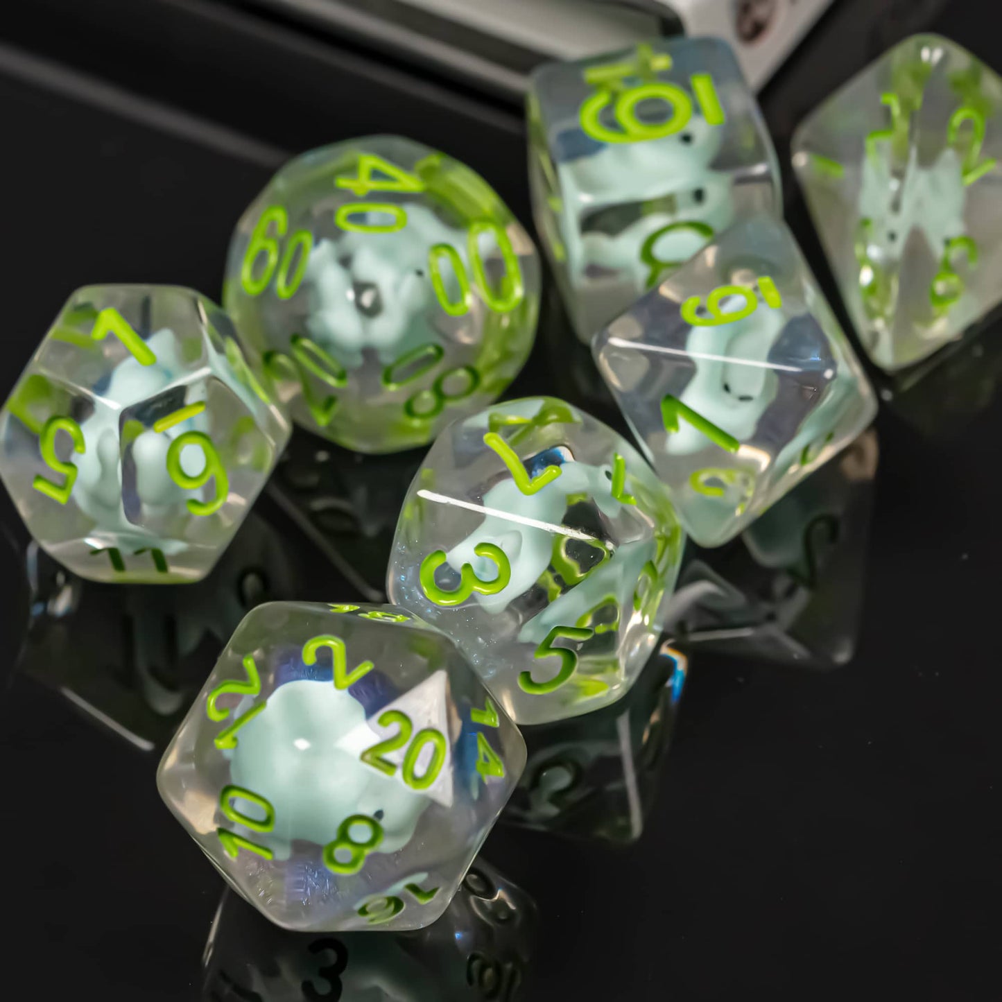 Transparent Dino Dice Set displayed on reflective black surface with bright green numbering