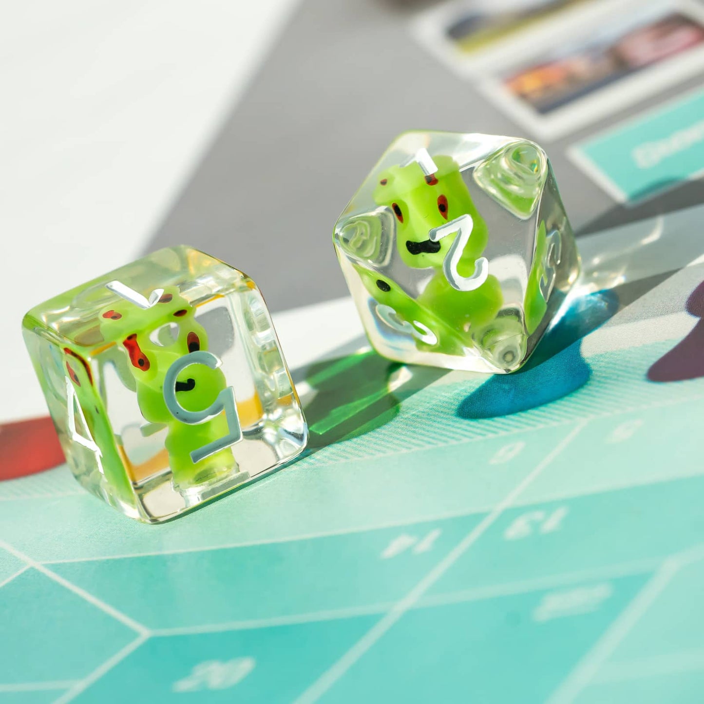 Pair of Transparent Froggo D6 dice highlighting green frog design and clear resin finish