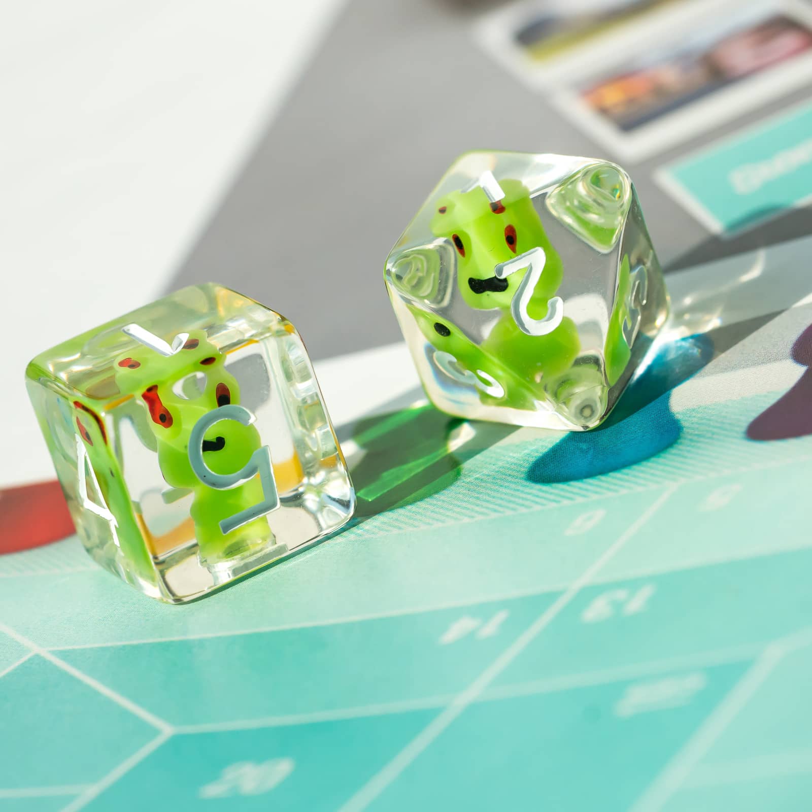 Pair of Transparent Froggo D6 dice highlighting green frog design and clear resin finish