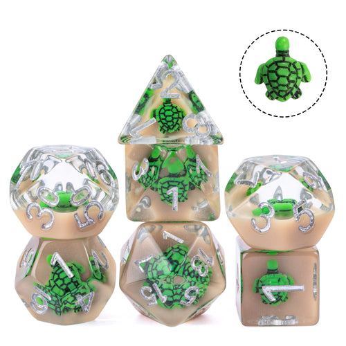 Green turtle dice set with mini turtle inside resin, silver numbering, closeup on white background