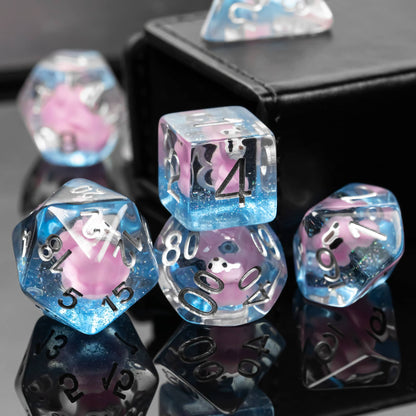 Detailed view of Transparent Pink Squirrel Dice Set with clear resin and sparkling blue accents