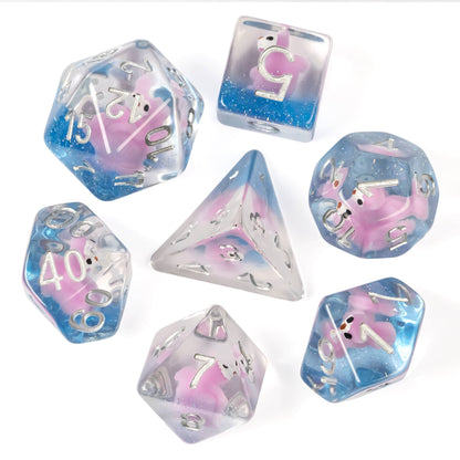 Flat lay of Transparent Pink Squirrel Dice Set showing seven dice with pink squirrel figures inside