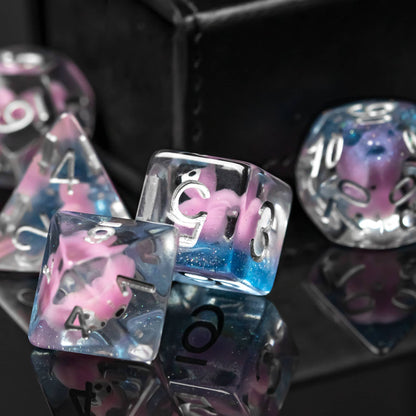 Transparent Pink Squirrel Dice Set displayed on black surface showing silver numbering