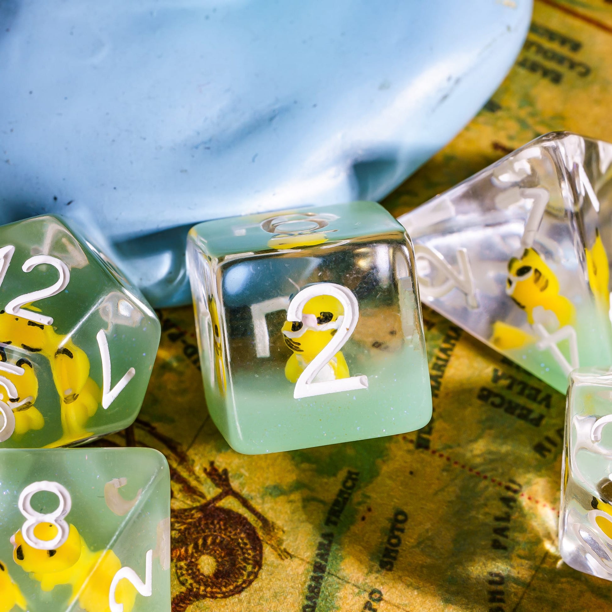 Closeup of Transparent Yellow Cat Dice Set with tiny yellow cat inside resin dice for DnD & TTRPG.