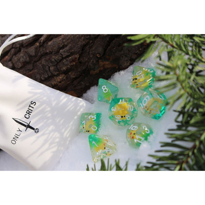  Transparent Yellow Ducky dice set for DnD & DnD 5e displayed in snow with Only Crits dice bag