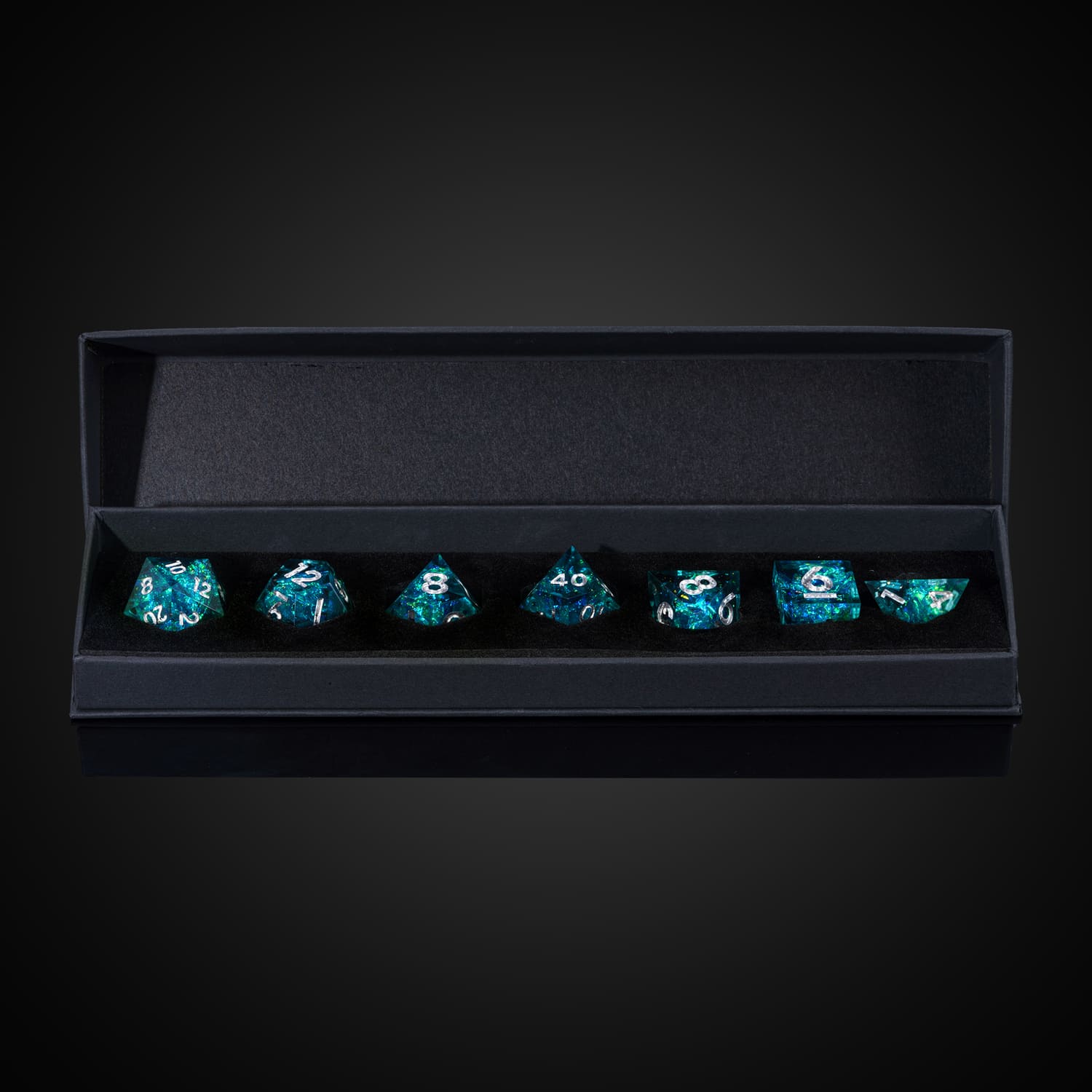 Turquoise Soul dice neatly arranged in black foam insert with box lid fully opened, premium RPG dice set