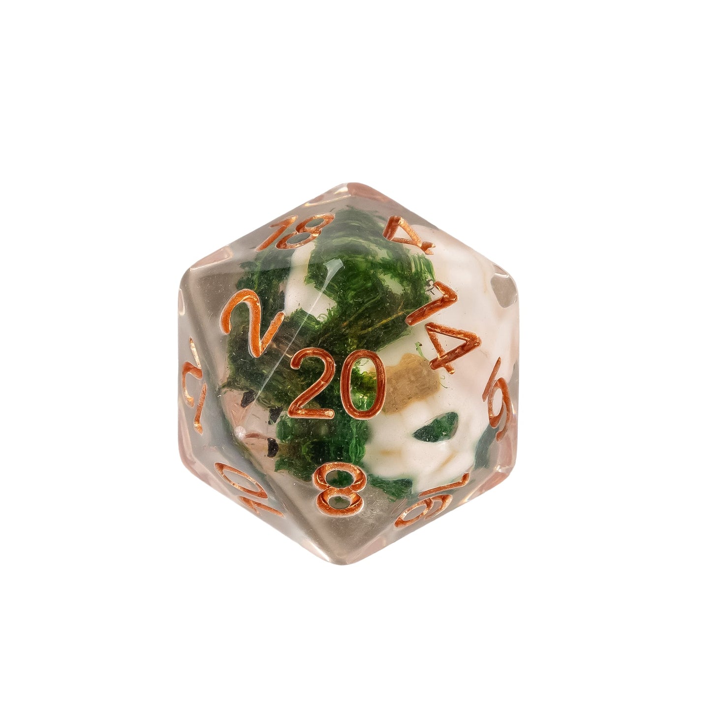Close up of Wizards Soul Cage Skull Dice D20 featuring a skull inclusion suspended in clear resin with moss details and copper numbering