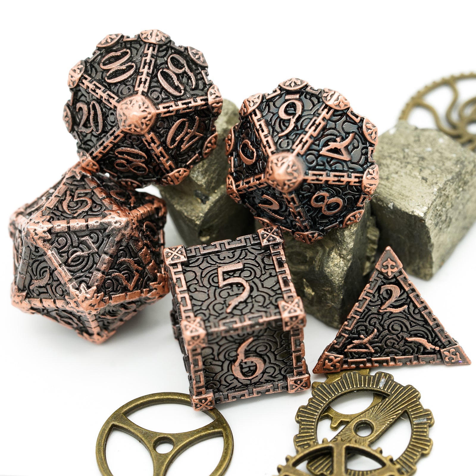 5 bronze metal dice with gears and rocks as background