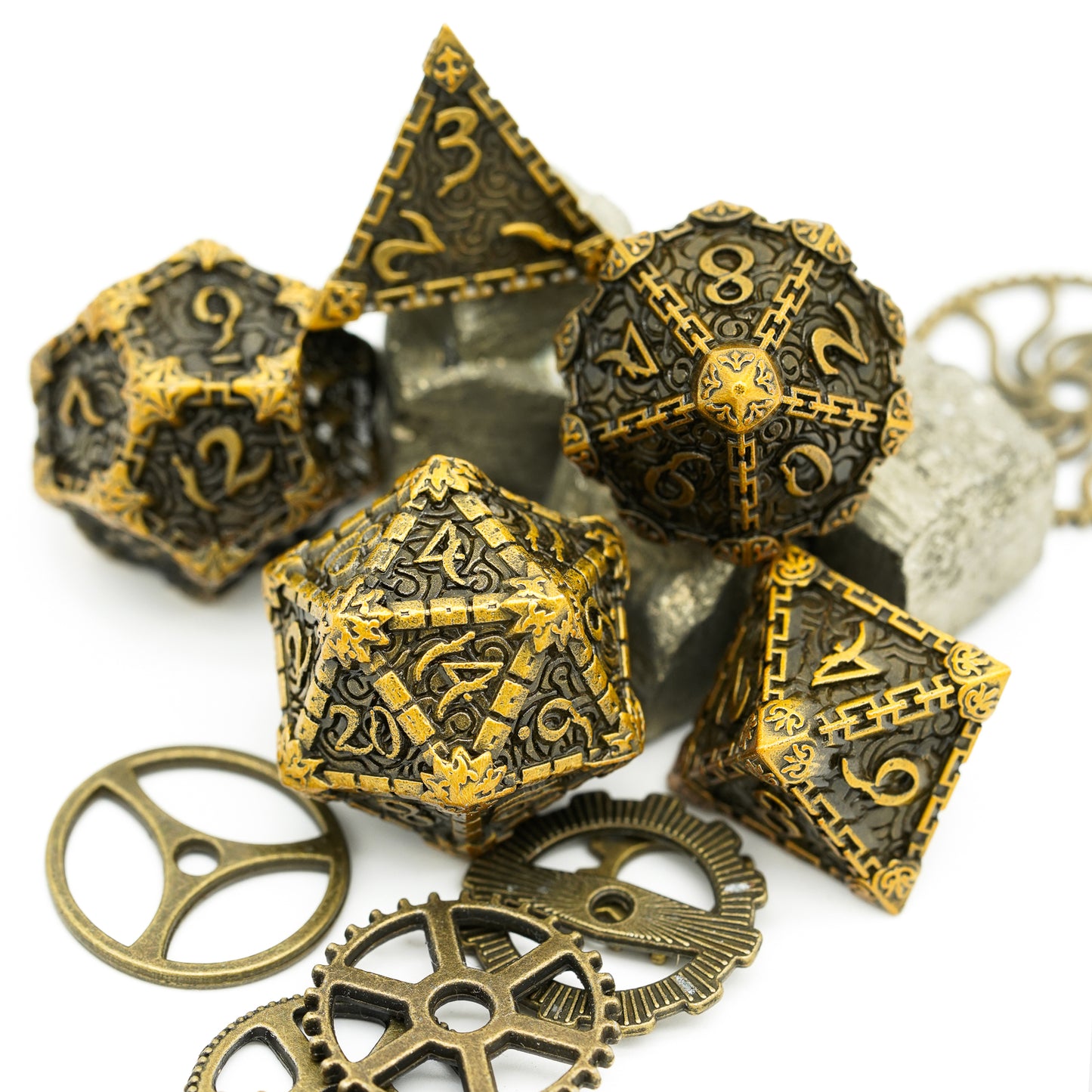 5 gold metal dagger dice with gears and rocks in background