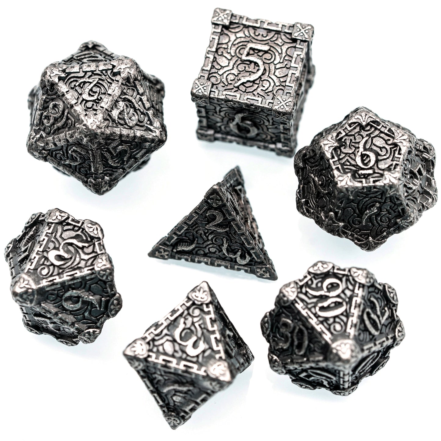 7 piece silver metal dice set arranged in circle on white background