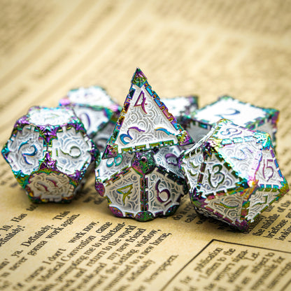 Snow Blade metal dagger dice set stacked on book pages