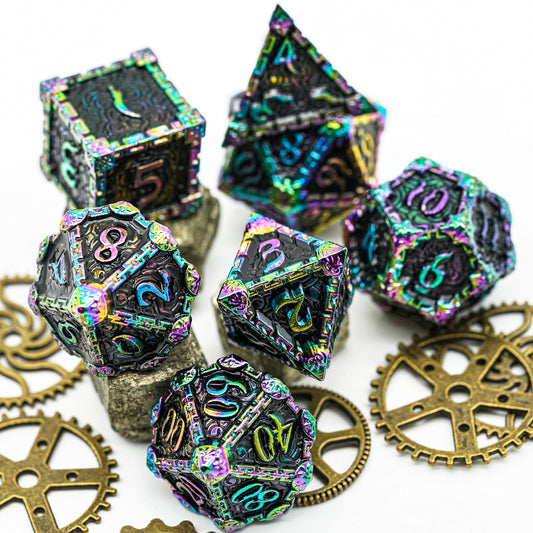 7 metal dice, rainbow colors on black background, presented with gears and rocks