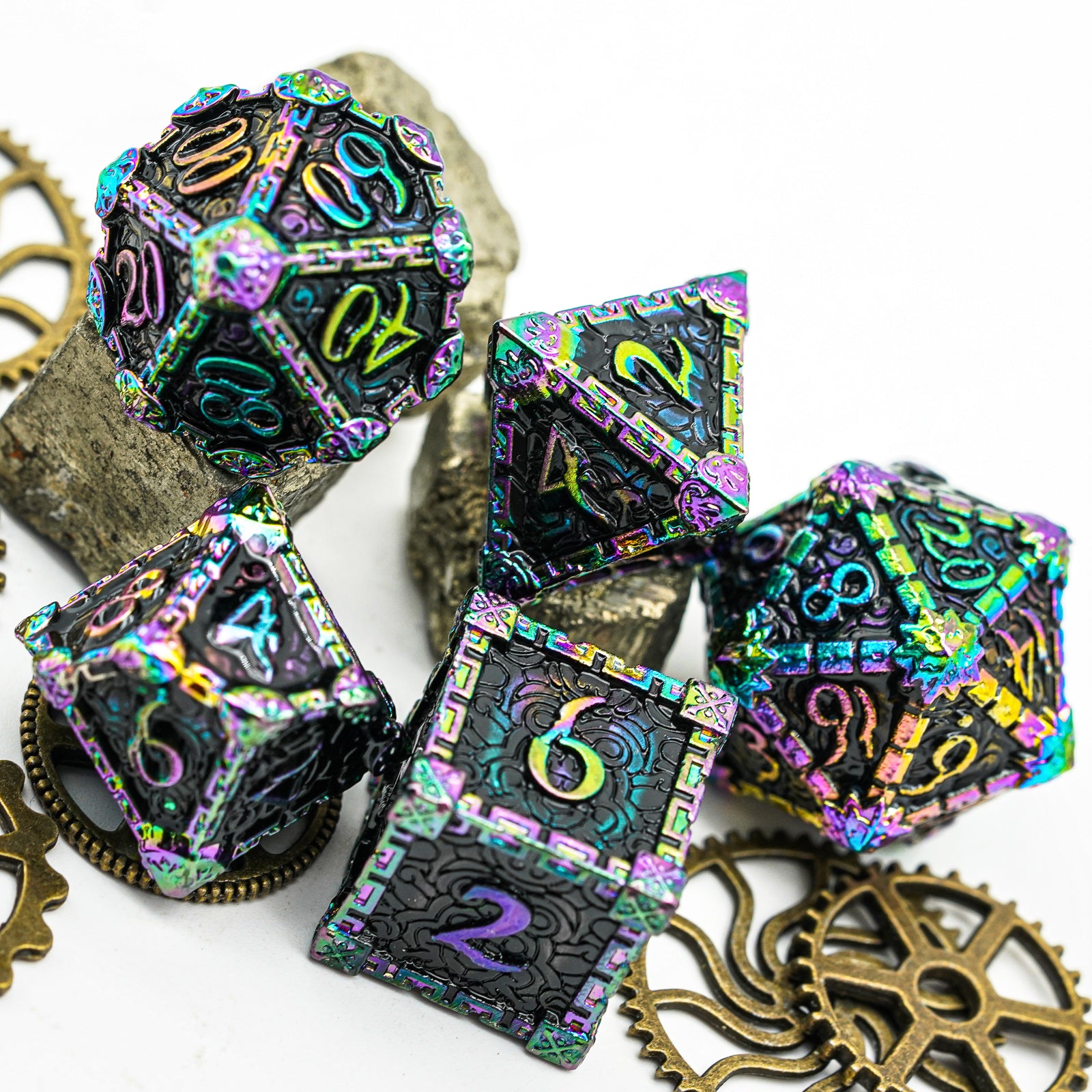 5 metal dice, rainbow on dark background, gears and stones in background