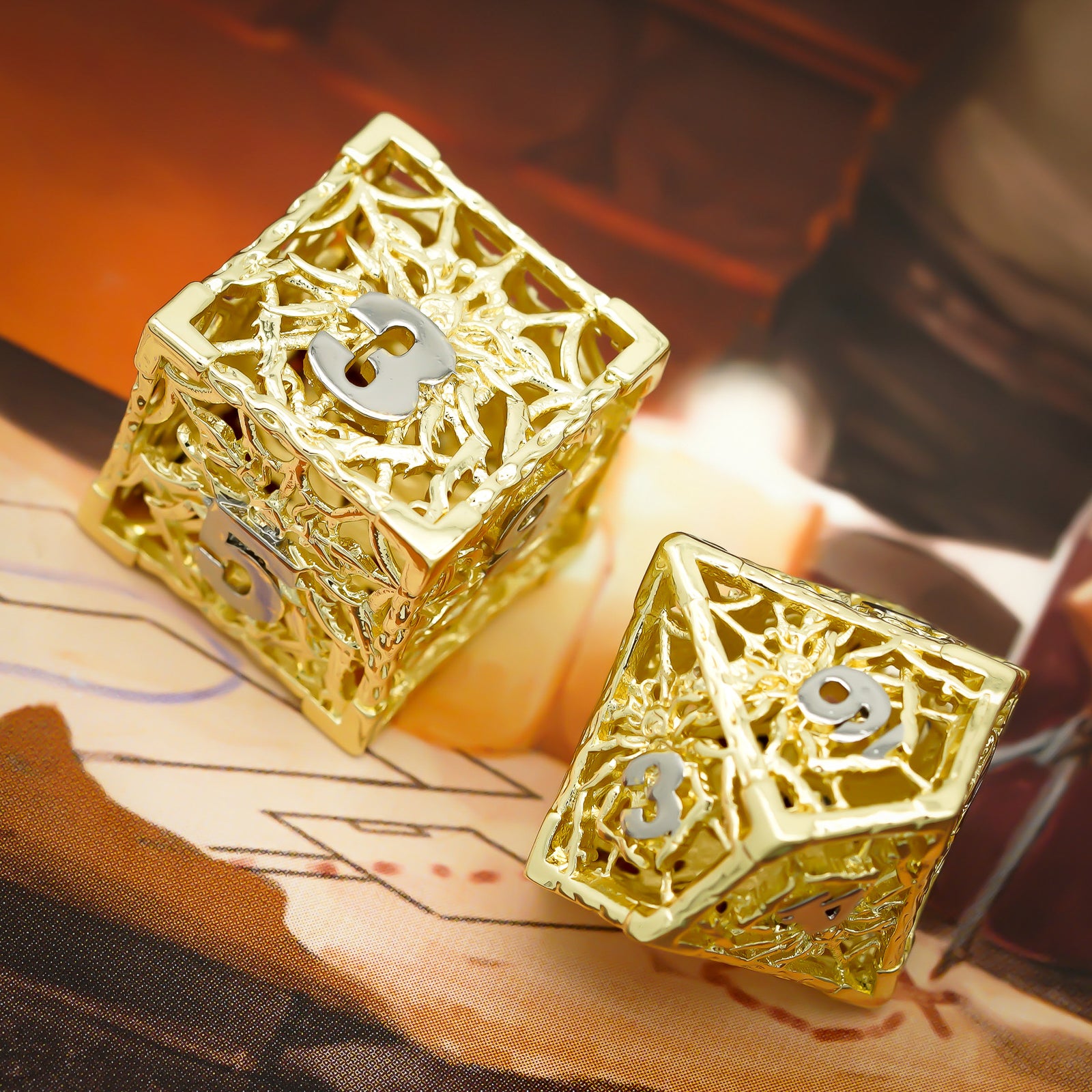 d6 and d10 gold hollow metal dice with silver numbers